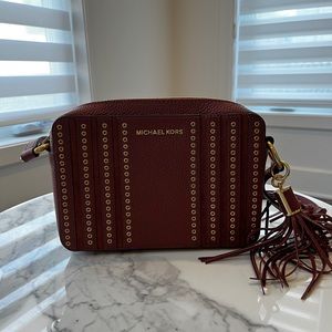 Michael Kors. Burgundy leather crossbody handbag.